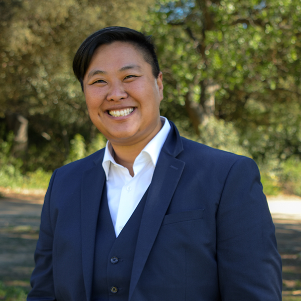 Photograph of Cecil Chik in a suit and white shirt outdoors